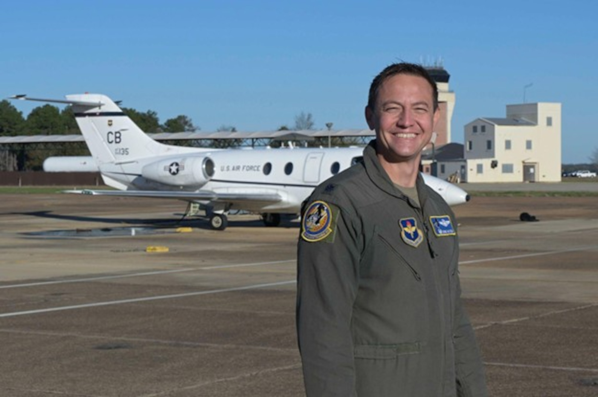 U.S. Air Force Lt. Col. Eddie Altizer, 48th Flying Training Squadron commander, looks back at a T-1A Jayhawk for the final time at Columbus Air Force Base, Mississippi, Nov. 26, 2025.
