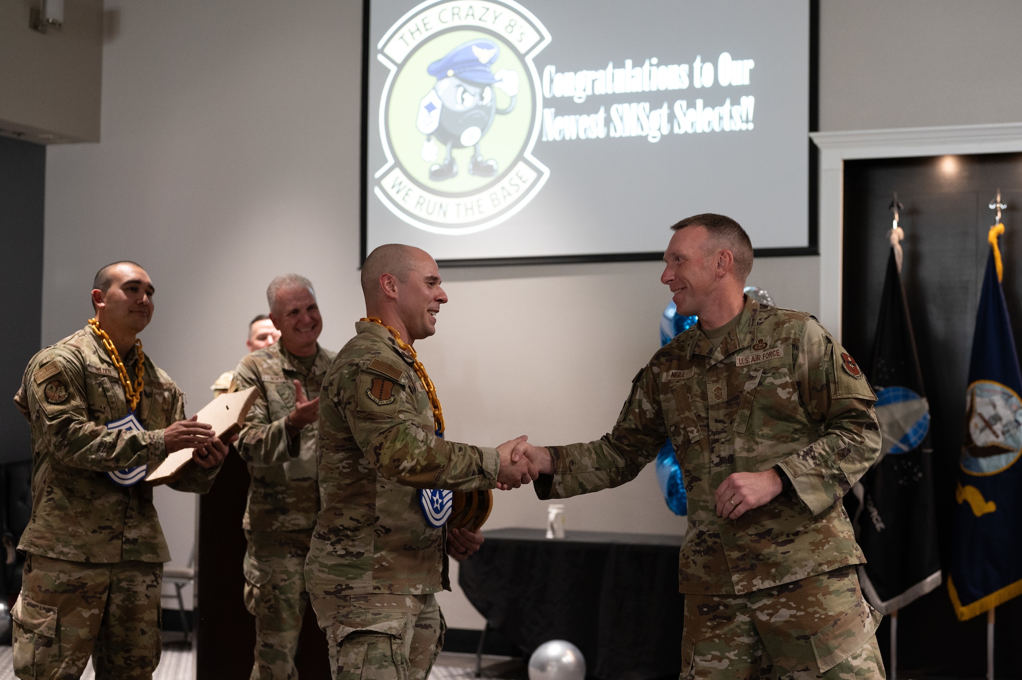 U.S. Air Force Senior Master Sgt. select Jedadiah Bauman, 17th Training Wing inspections & unit self-assessment manager, is coined by Chief Master Sgt. Derek Neill, 17th TRW command chief, during the Senior Master Sergeant Release Party