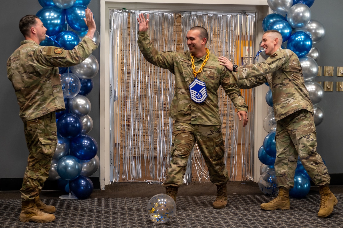 U.S. Air Force Senior Master Sgt. select Justin E. Holden, 17th Contracting Squadron, is greeted and congratulated by peers, during the Senior Master Sergeant Release Party