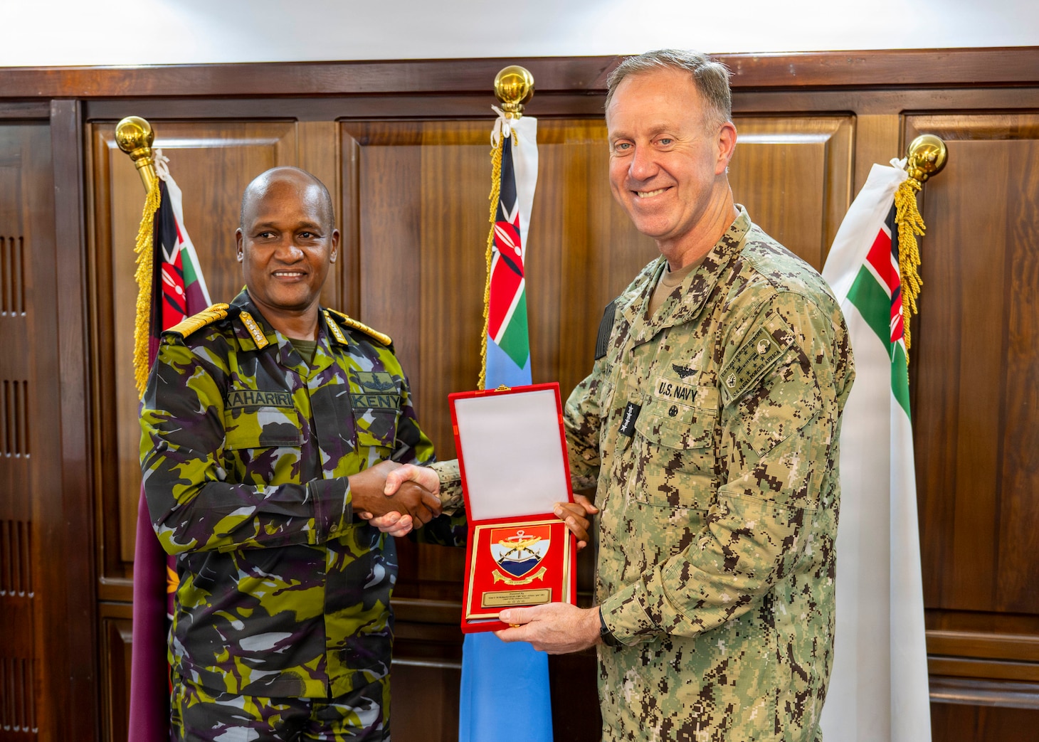Adm. George Wikoff and General Charles Kahariri exchange gifts at the Defence Headquarters in Nairobi.