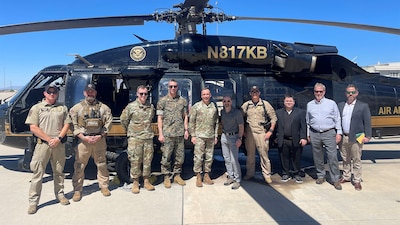 Participants in front of  helicopter