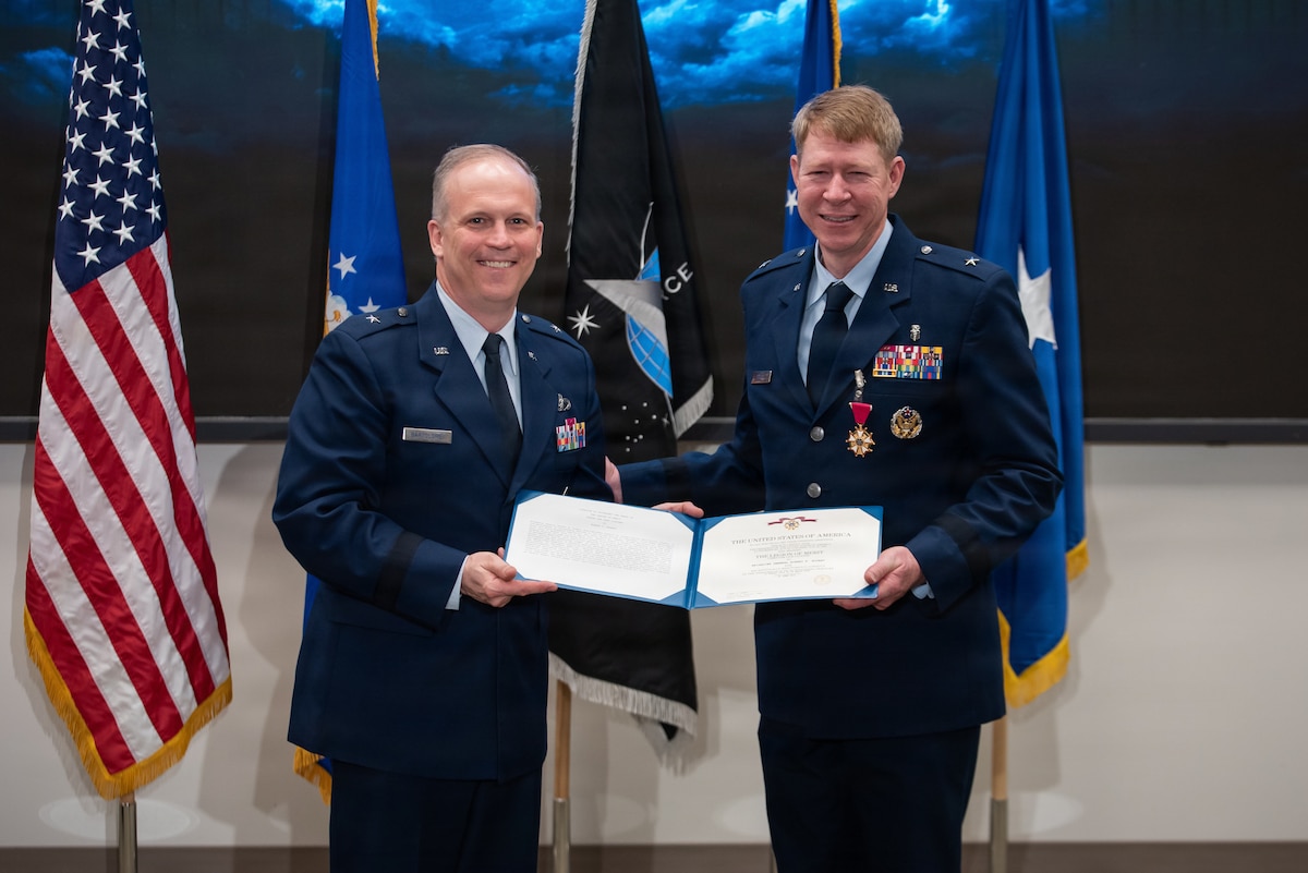 Brig. Gen. Jason Bartolomei, left, Air Force Research Laboratory commander, presents the Legion of Merit to Brig. Gen. (Dr.) Robert Bogart, right, outgoing commander of the 711th Human Performance Wing, during the Wing’s change of command ceremony at Wright-Patterson Air Force Base, Ohio, March 30, 2026.