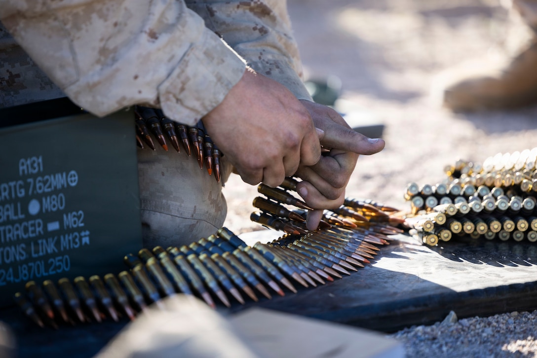 A Marine prepares 7.62 mm ammunition