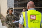 Chief Master Sgt. Shakela Matthews, left, 433rd Force Support Squadron senior enlisted leader, and 1st Lt. Anthony Martin, 433rd FSS operations officer, speak with Sean Yonder, Military and Family Readiness coordinator, during an Emergency Resilience Readiness Exercise at Joint Base San Antonio-Lackland, Texas, March 24, 2026. JBSA conducted the preplanned exercise March 24–27 to ensure personnel are prepared to respond to a potential severe weather event and widespread power outage. (U.S. Air Force photo by Marcus Robins)