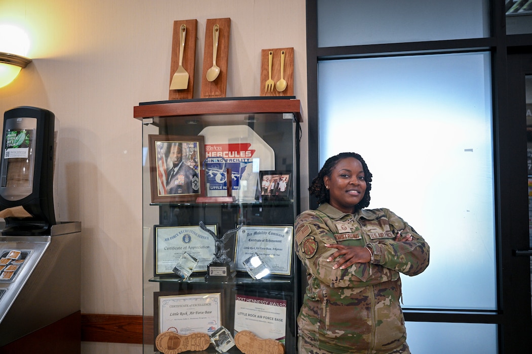 Woman poses with trophy case.