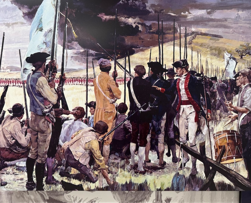 Men in a variety of Revolutionary War-era military uniforms wield muskets, play a drum and carry flags.