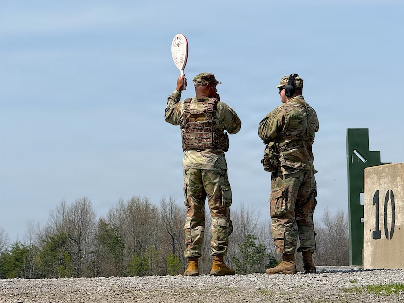 U.S. Army Chief Warrant Officer 2 Yuri Dunklin speaks with Capt. Donovan Alexander, commander of Headquarters and Service Company, 103rd Brigade Support Battalion during M4 qualification at Wendell H. Ford Regional Training Center in Greenville, March 20, 2026.