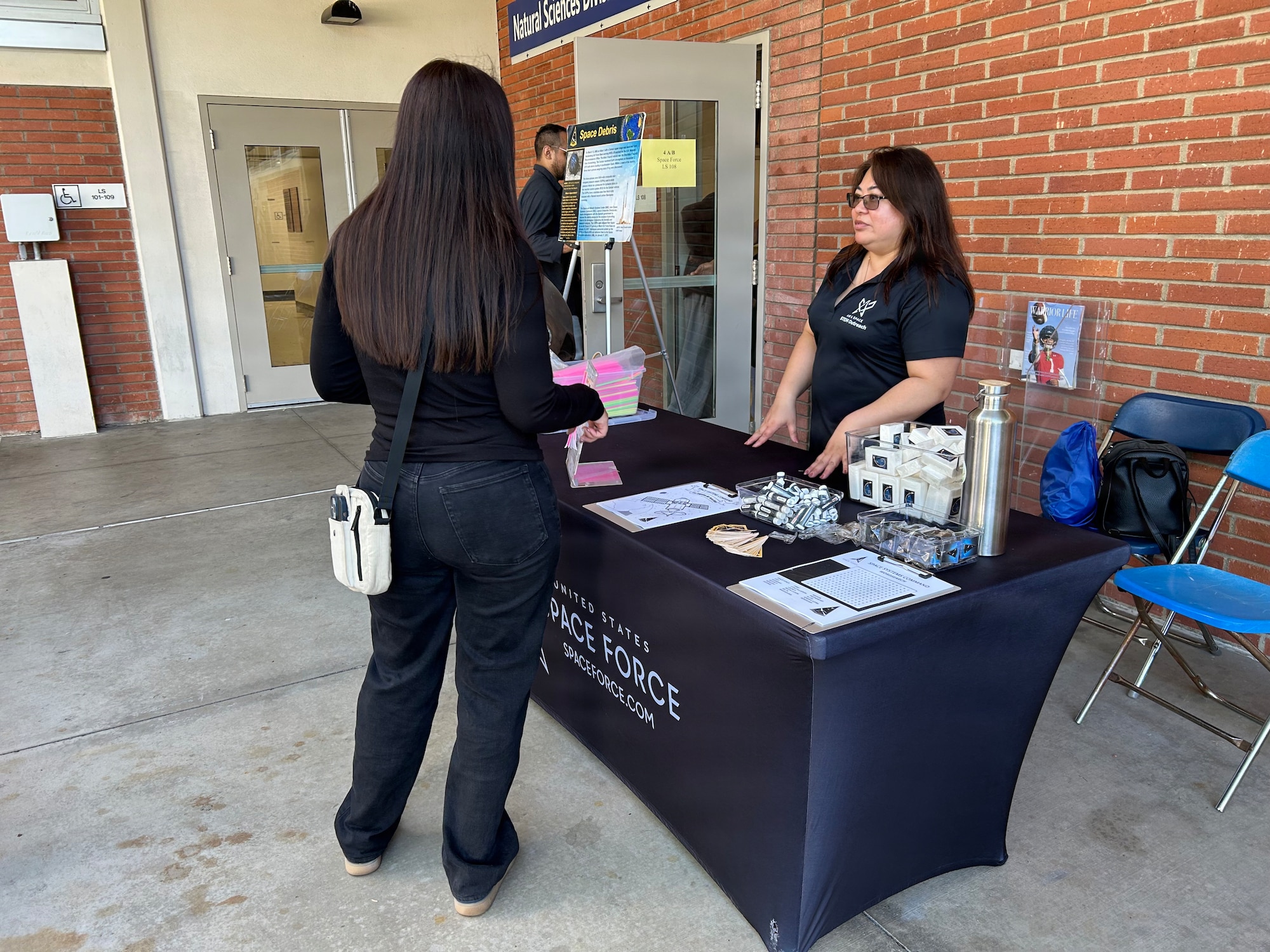 U.S. Space Force’s Space Systems Command (SSC) STEM Team participates in Onizuka Space Days at El Camino College in Torrance, Calif., on March 14, 2026.  Space Based Delta 3’s Heritage Center director Layesanna Rivera speaks with students at SSC's informational exhibit. Onizuka Space Days honors the memory of NASA astronaut and U.S. Air Force Test Pilot, Lt. Col. Ellison Onizuka. [[USSF Photo by: Michiko Riley, SSC/PA]