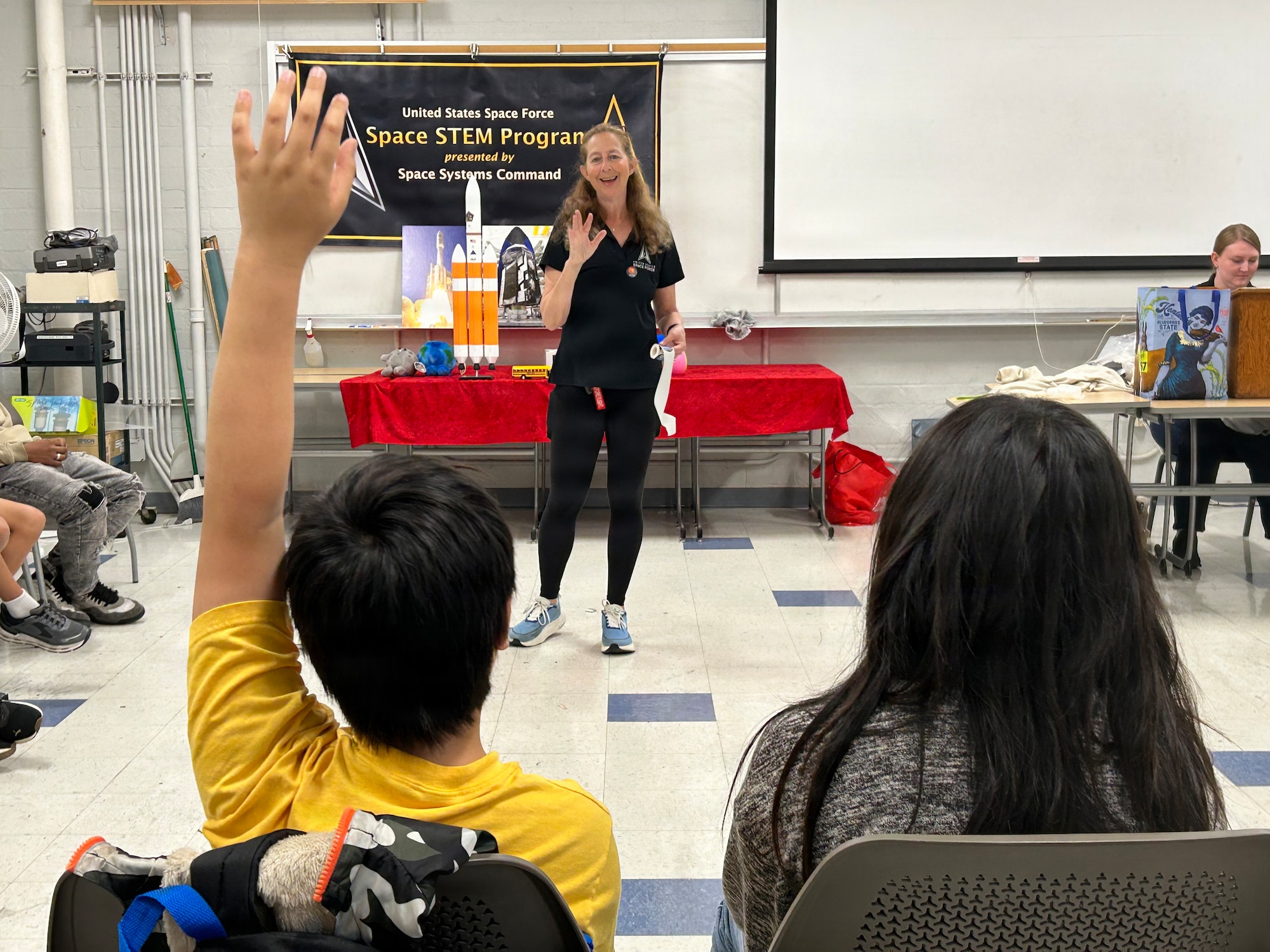 U.S. Space Force’s Space Systems Command (SSC) STEM Team participates in Onizuka Space Days at El Camino College in Torrance, Calif. on March 14, 2026. New York University Tisch-trained actor and SSC STEM specialist Nicole Tibbetts, led two interactive classroom sessions focused on rocketry, USSF satellite systems, and SSC launch capabilities. Each session hosted 35 students and 15 parents from the local community. Onizuka Space Days honors the memory of NASA astronaut and U.S. Air Force Test Pilot, Lt. Col. Ellison Onizuka. [USSF Photo by: Michiko Riley, SSC/PA]