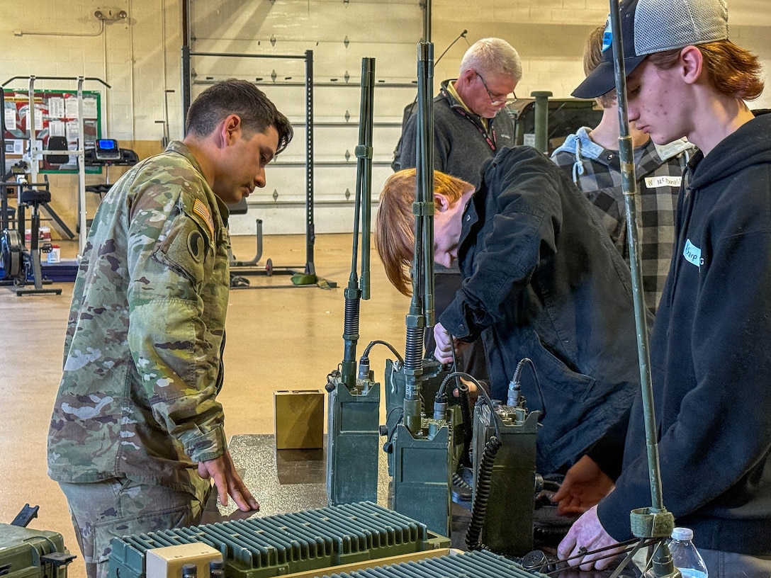Students practice programming tactical radios under the guidance of U.S. Army Sgt. William Helton, assigned to Delta Company, 1st Battalion, 149th Infantry, 75th Troop Command, during a job shadow event in Bardstown, Kentucky, March 24.