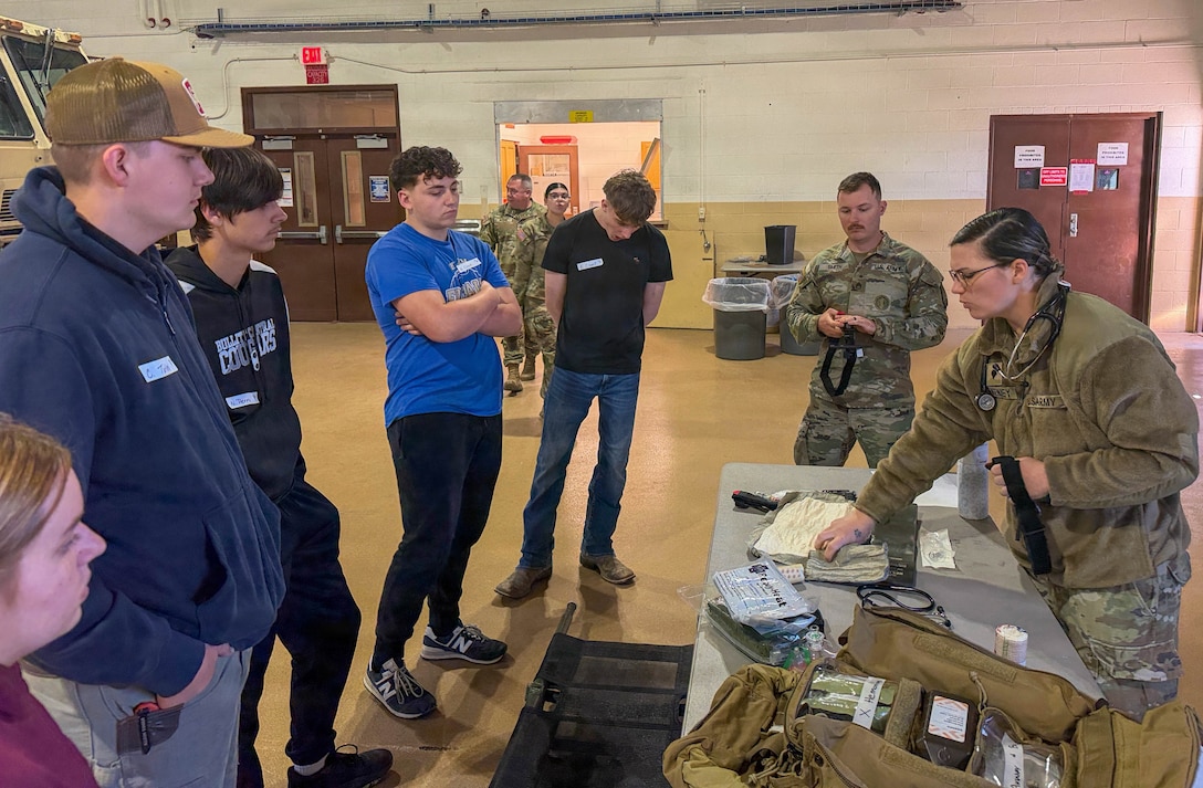 U.S. Army Spc. Haven McKenney, assigned to the 103rd Brigade Support Battalion, 38th Infantry Division Artillery, demonstrates medical equipment used in combat casualty care to students during a job shadow event in Bardstown, Kentucky, March 24.