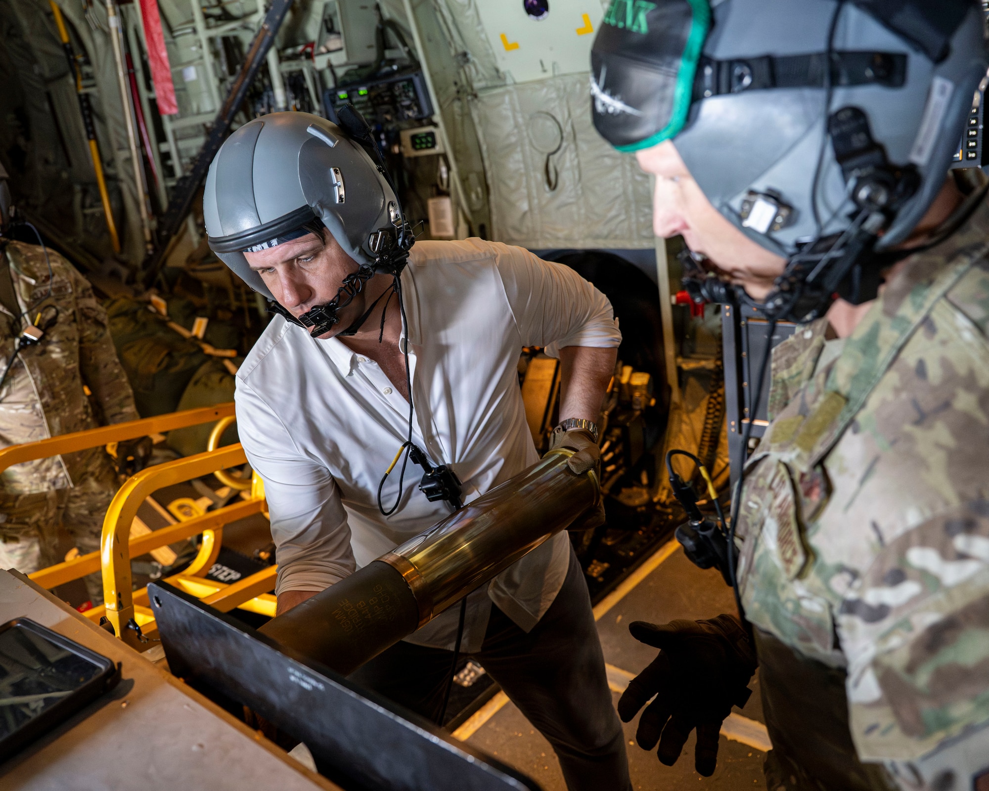 Derrick Anderson, Assistant Secretary of War for Special Operations and Low-Intensity Conflict, loads a 105 mm round aboard a 1st SOW AC-130J Ghostrider.