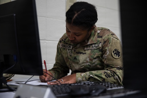 U.S. Army Sgt. Jamila Ferguson, a human resources sergeant representing the Marietta-based 781st Troop Command Detachment, 78th Troop Command, Georgia Army National Guard, writes during the Essay event of the 2026 78th Troop Command-78th Aviation Troop Command Joint Best Warrior Competition Feb. 21, 2026, at the Clay National Guard Center, Marietta, Georgia. The competition demonstrates the readiness and lethality of the 78th Troop Command and 78th Aviation Troop Command Soldiers by testing the competitors with physical fitness assessments, written exams, and other warrior tasks and battle drills. (U.S. Army National Guard photo by Sgt. 1st Class James Braswell)