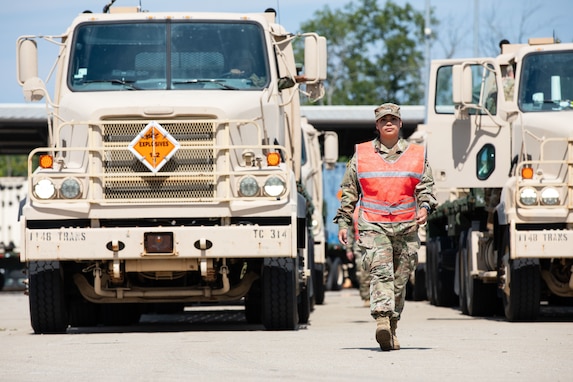 U.S. Army Sgt. Carmen Bargeron, a motor sergeant with the Fort Eisenhower-based 1148th Transportation Company, 110th Combat Sustainment Support Battalion, 78th Troop Command, Georgia Army National Guard, guides a M915A5 line-haul tractor truck operator towards the ammunition pick-up area during Operation Patriot Press 2024 July 19, 2024, at the Blue Grass Army Depot, Richmond, Kentucky. This exercise, established by the Army Materiel Command, is designed to promote readiness by providing real-world training for Army requirements and to achieve training towards Mission Essential Task requirements for Army active duty, Army Reserve, National Guard, and various other service branches. (U.S. Army National Guard photo by Sgt. 1st Class James Braswell)
