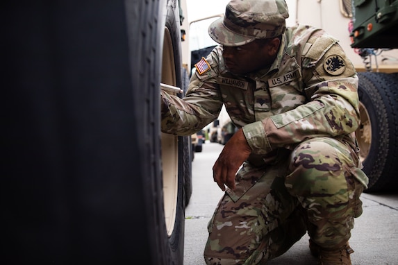 U.S. Army Spc. Patrick Williamson, a motor trasport operator with the Fort Eisenhower-based 1148th Transportation Company, 110th Combat Sustainment Support Battalion, 78th Troop Command, Georgia Army National Guard, checks the tire air pressure levels of M915A5 line-haul tractor truck during Operation Patriot Press 2024 July 20, 2024, at the Blue Grass Army Depot, Richmond, Kentucky. This exercise, established by the Army Materiel Command, is designed to promote readiness by providing real-world training for Army requirements and to achieve training towards Mission Essential Task requirements for Army active duty, Army Reserve, National Guard, and various other service branches. (U.S. Army National Guard photo by Sgt. 1st Class James Braswell)