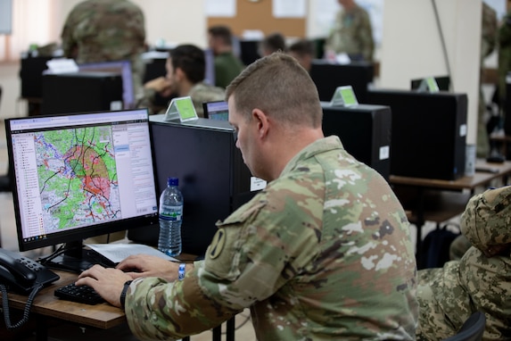 U.S. Army Maj. Samuel Wolfson, assigned to the Georgia Army National Guard, inputs data into the command and control system during a simulated scenario at Krtsanisi Training Area, Georgia, Aug. 4, 2025, in support of Agile Spirit 25. As part of the exercise’s multinational command post operations, Wolfson contributed to planning and coordinating tactical movement across the simulated battlefield. Agile Spirit 25 reinforces strategic partnerships and enhances interoperability among NATO allies and partner nations. (U.S. Army National Guard photo by Sgt. 1st Class Brittany Conley)