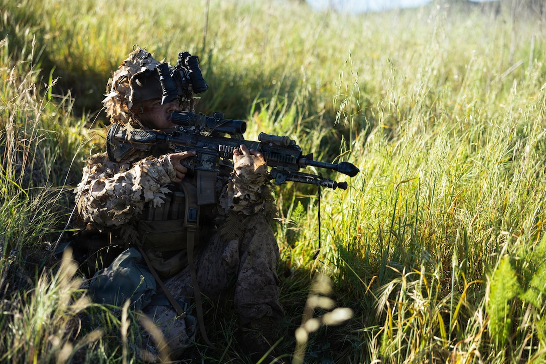 A U.S. Marine with 1st Marine Division holds security during the annual 1st MARDIV squad competition at Marine Corps Base Camp Pendleton, California, March 18, 2026.