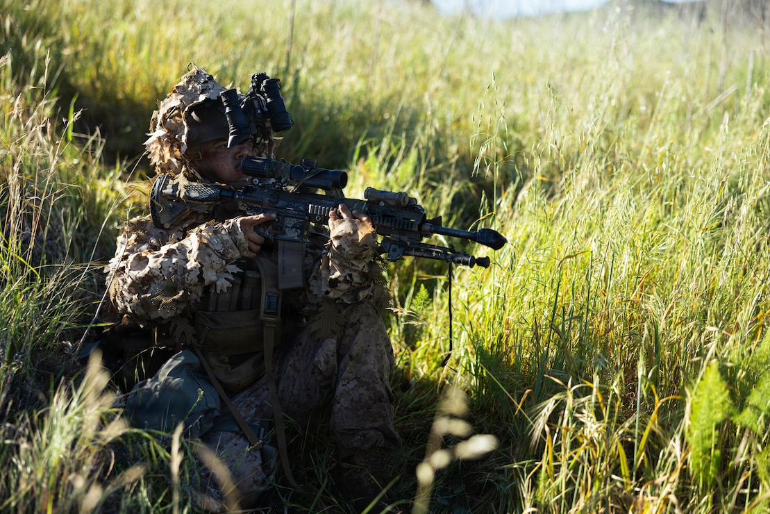 A U.S. Marine with 1st Marine Division holds security during the annual 1st MARDIV squad competition at Marine Corps Base Camp Pendleton, California, March 18, 2026.