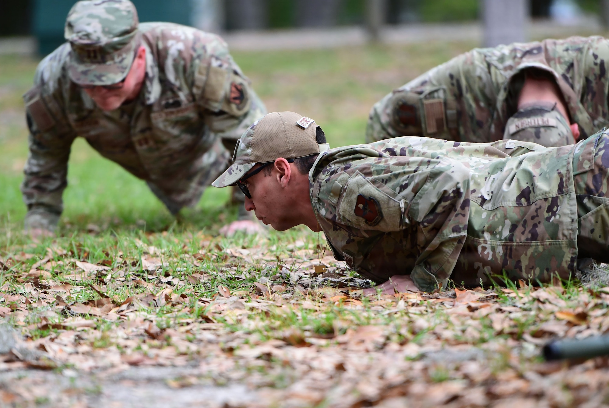 A group of military people do push-ups.