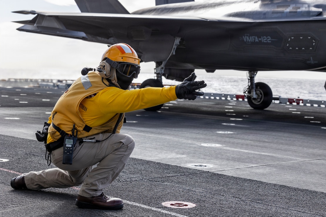U.S. Navy Aviation Boatswains’ Mate (Handling) Chief Petty Officer Naval Francisco assigned to Wasp-class amphibious assault ship USS Boxer (LHD 4), signals a U.S. Marine Corps F-35B Lightning II attached to Marine Fighter Attack Squadron (VMFA) 122, 11th Marine Expeditionary Unit, to take off during deck landing qualifications in the Pacific Ocean, March 28, 2026.