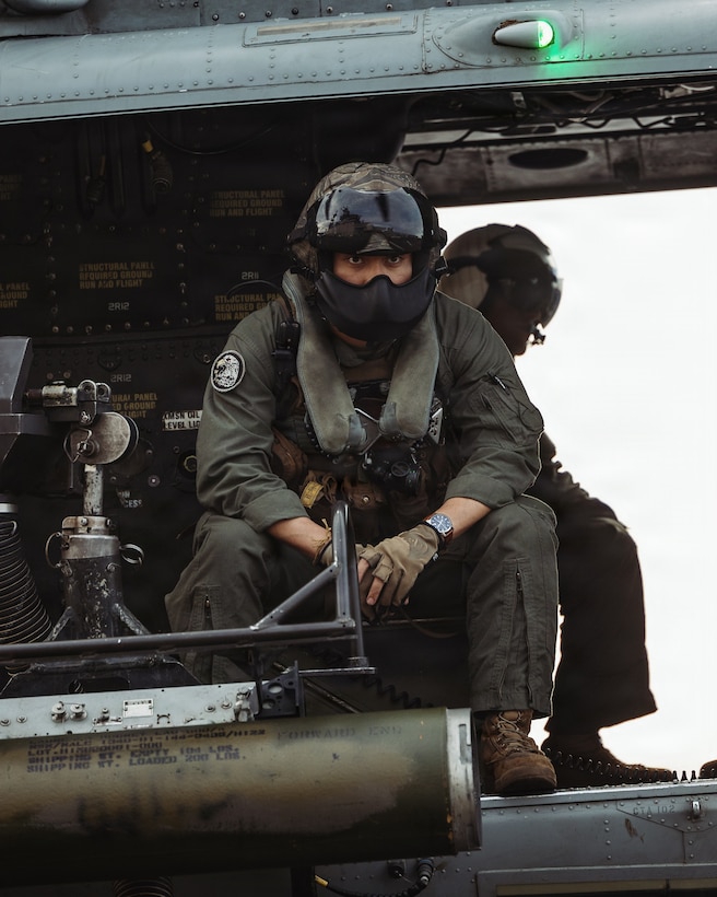 A U.S. Marine Corps UH-1Y Venom crew chief with Marine Medium Tiltrotor Squadron (VMM) 163 (Reinforced), 11th Marine Expeditionary Unit, prepares to take off from the flight deck of Wasp-class amphibious assault ship USS Boxer (LHD 4) in the Pacific Ocean, March 28, 2026.