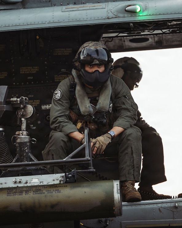 A U.S. Marine Corps UH-1Y Venom crew chief with Marine Medium Tiltrotor Squadron (VMM) 163 (Reinforced), 11th Marine Expeditionary Unit, prepares to take off from the flight deck of Wasp-class amphibious assault ship USS Boxer (LHD 4) in the Pacific Ocean, March 28, 2026.