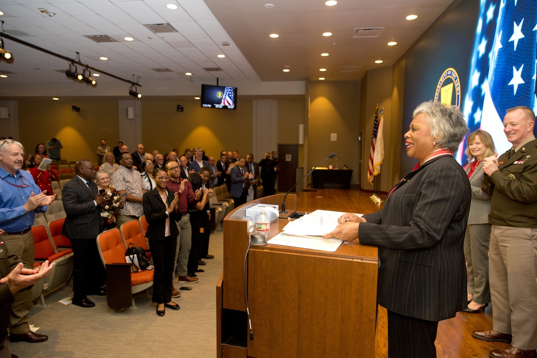 Patricia M. Sullivan, Senior Executive Service, receives a standing ovation.