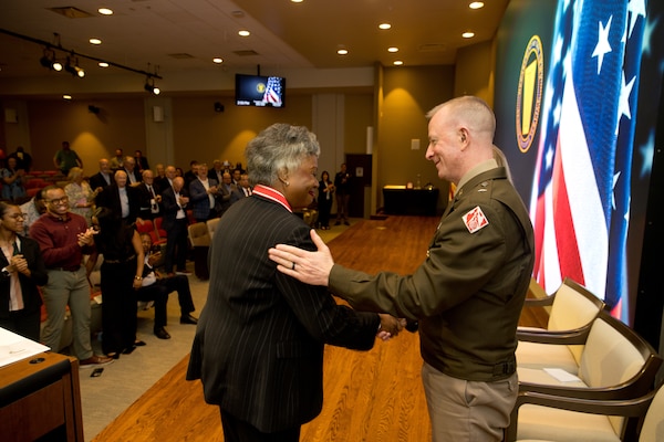 Brig. Gen. Kirk Gibbs, deputy chief of engineers and deputy commanding general of the U.S. Army Corps of Engineers, congratulates Patricia M. Sullivan, Senior Executive Service.