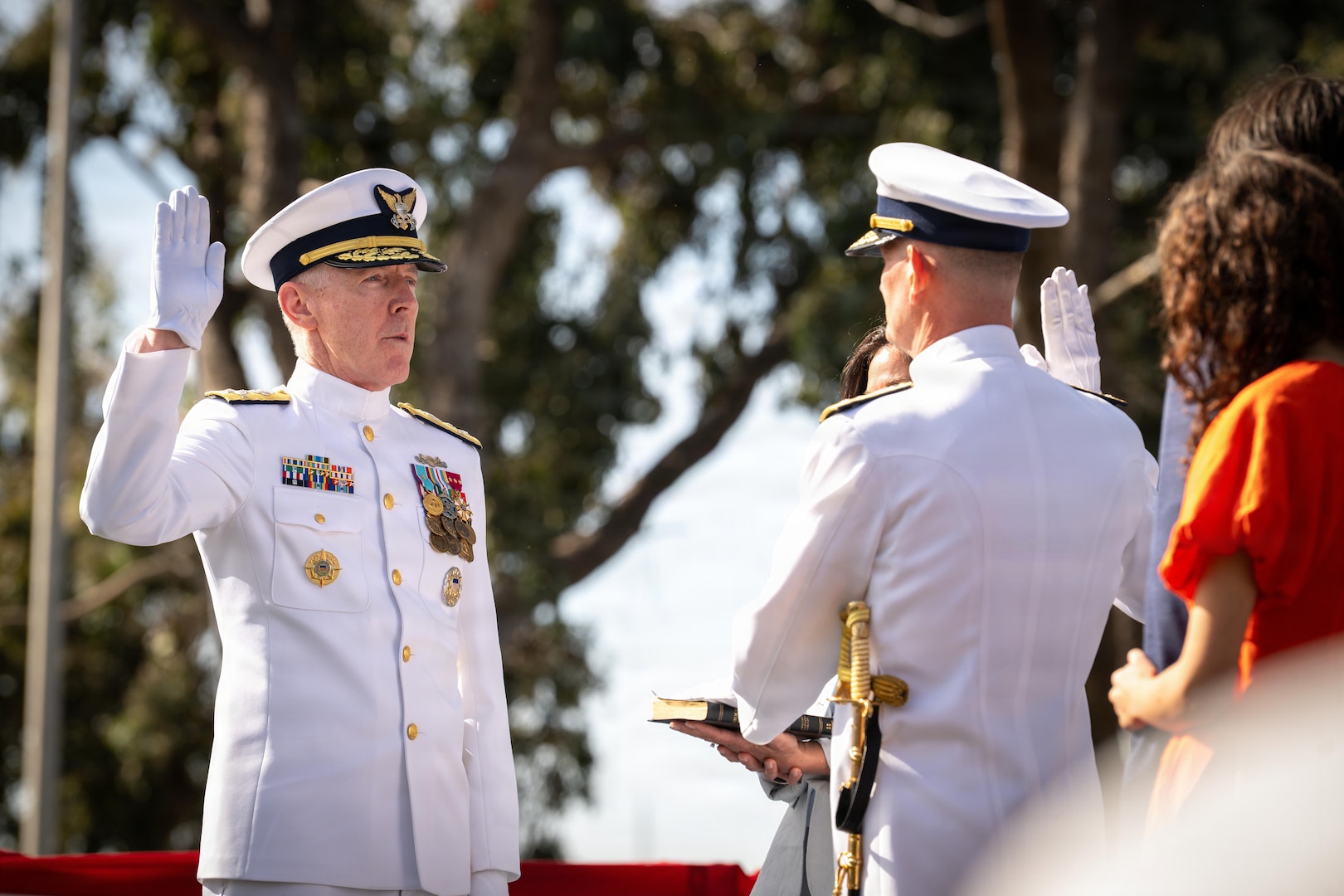 Vice Adm. Joe Buzzella, commander of Coast Guard Pacific Area and Defense Force West, recites the oath of office with Adm. Kevin Lunday, commandant of the U.S. Coast Guard, during his assumption of command ceremony, March 26, 2026, at Coast Guard Island, Alameda, California. Lunday presided over the ceremony which formally confirmed Buzzella as the commander of Coast Guard Pacific Area and Defense Force West.  (U.S. Coast Guard photo by Petty Officer 3rd Class Kenneth Wiese)