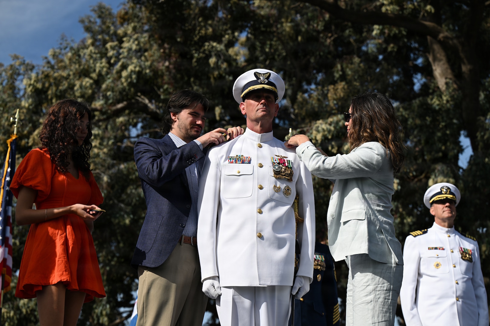 Members of Vice Adm. Joe Buzzella’s family put on his new shoulder boards during his promotion to vice admiral during the Pacific Area assumption of command ceremony in Alameda, California, March 26, 2026. As commander of the Coast Guard Pacific Area and Defense Force West, Buzzella oversees all Coast Guard operations across the Pacific theater- an area encompassing more than 74 million square miles. (U.S. Coast Guard photo by Petty Officer 3rd Class Austin Wiley)
