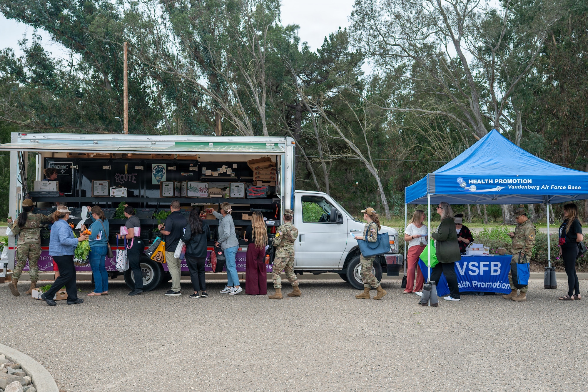 Team Vandenberg servicemembers and families stand in line to receive produce during a Health Promotion Team produce truck event.