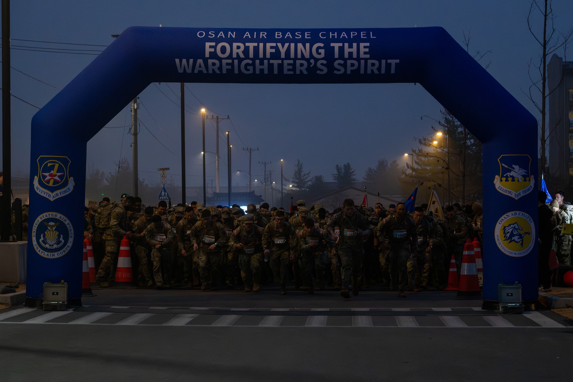 Service members leave the start line as they begin a 30km ruck.