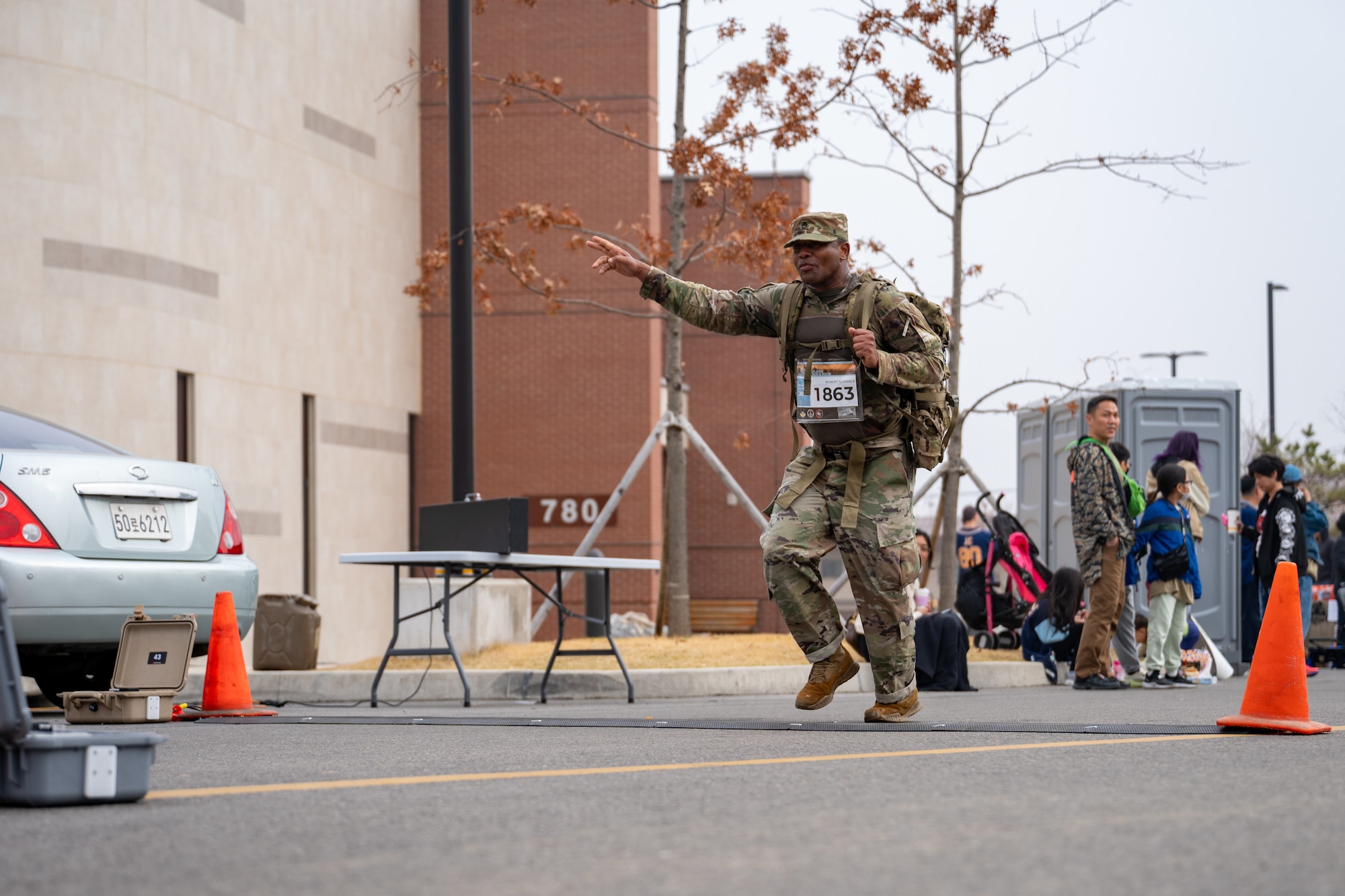 A rucker waves as he reaches a turnaround point during a 30km ruck.
