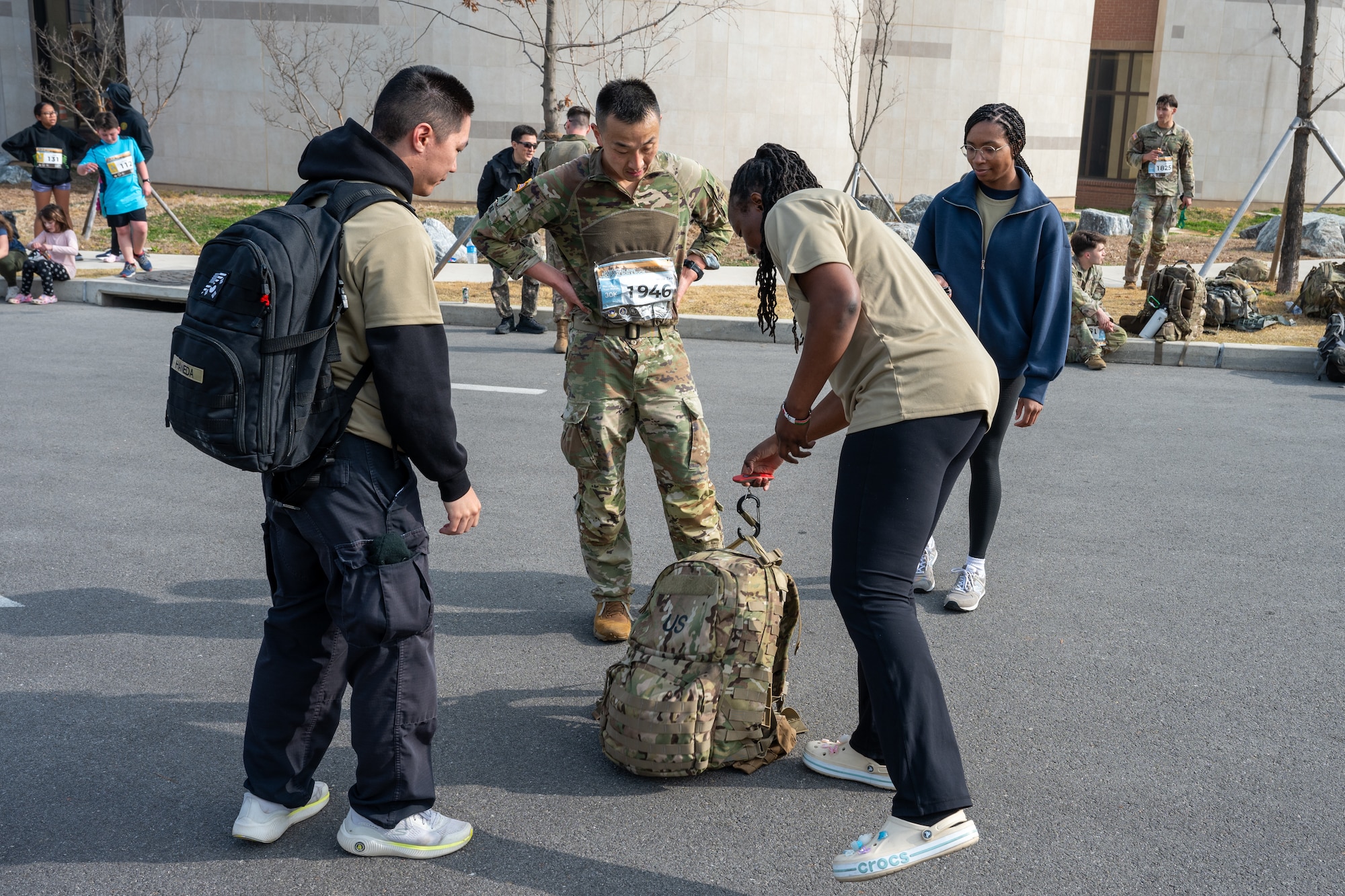 Volunteers weigh a ruck sack after a participant finished a 30km ruck.