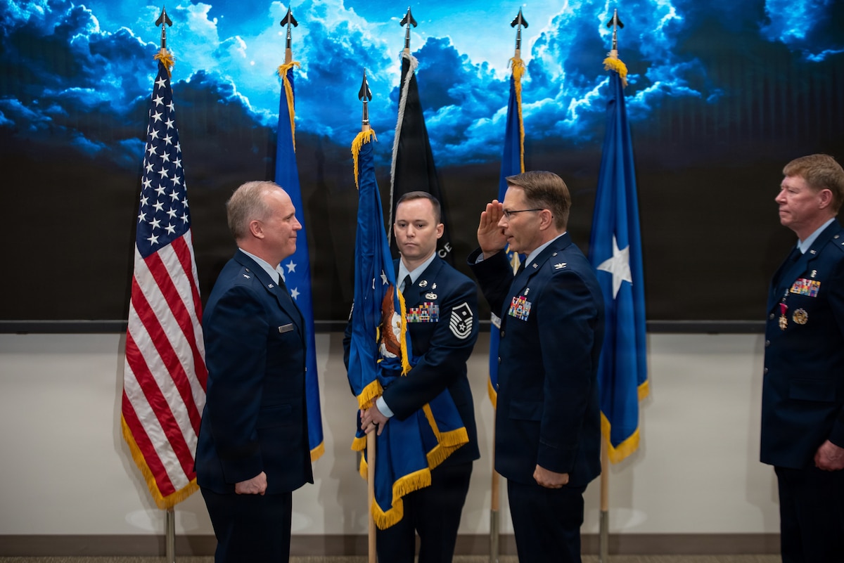Incoming 711th Human Performance Wing commander Col. Dale Harrell, salutes Brig. Gen Jason Bartolomei, commander, Air Force Research Laboratory after taking command of AFRL’s 711 HPW from Brig. Gen. (Dr.) Robert Bogart, far right, at a change of command ceremony at Wright-Patterson Air Force Base, Ohio, March 30, 2026.