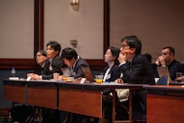 Japan Customs officials and other Japanese partners listen during opening comments at the U.S. Forces Japan Law Enforcement Symposium April 22, 2026, at the New Sanno Hotel in Tokyo, Japan.