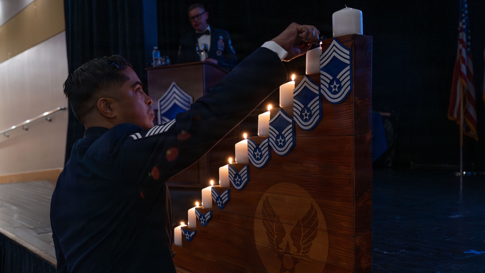 A U.S. Air Force senior master sergeant assigned to the 51st Fighter Wing, lights his respective candle during a chief master sergeant recognition ceremony at Osan Air Base, Republic of Korea, April 24, 2026. The recognition marks a transition into greater responsibility as chiefs continue to lead, mentor and advocate for Airmen. (U.S. Air Force photo by Senior Airman Rome Bowermaster)