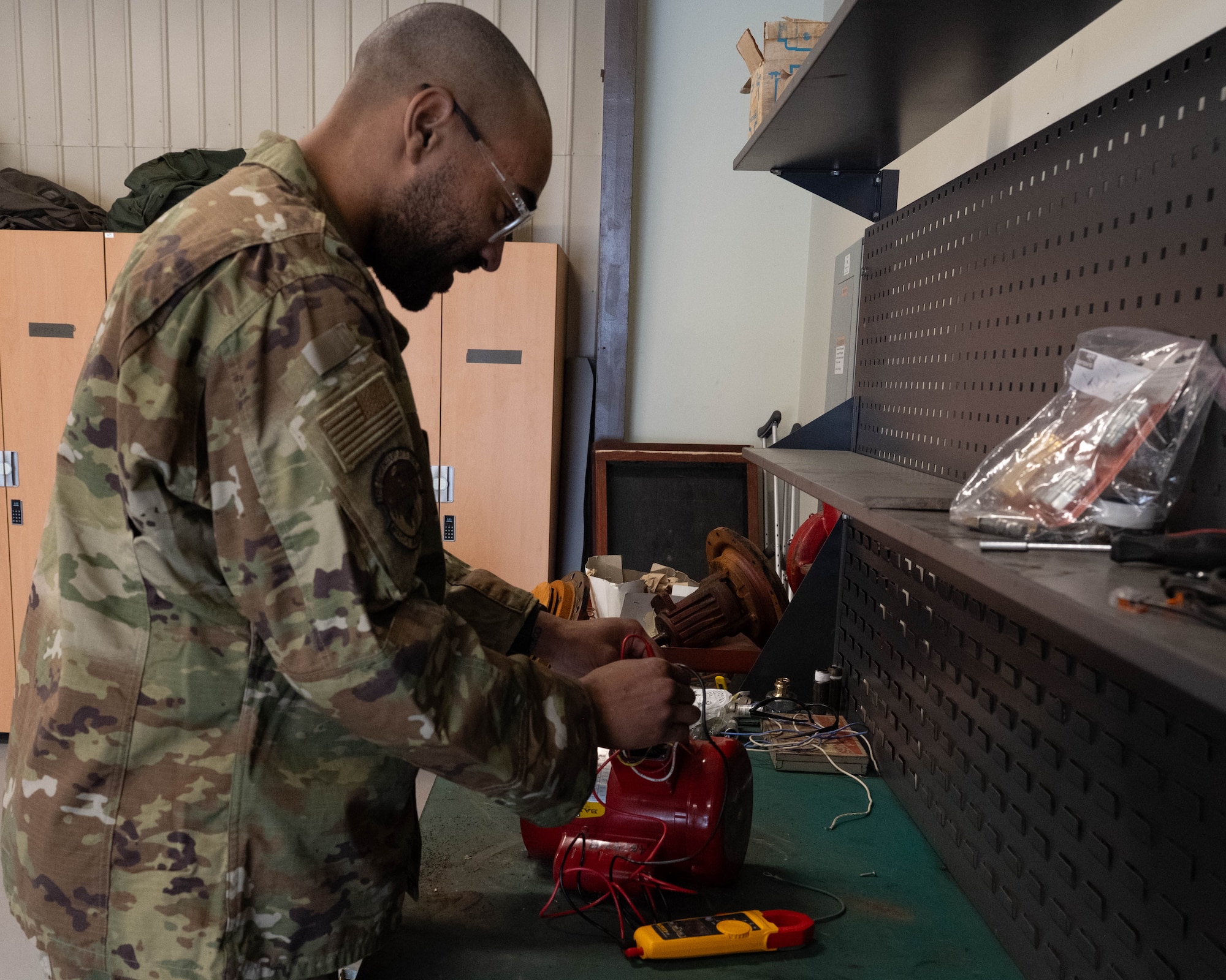 Airman works on pump motor.