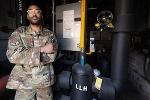 Airman poses with tools.