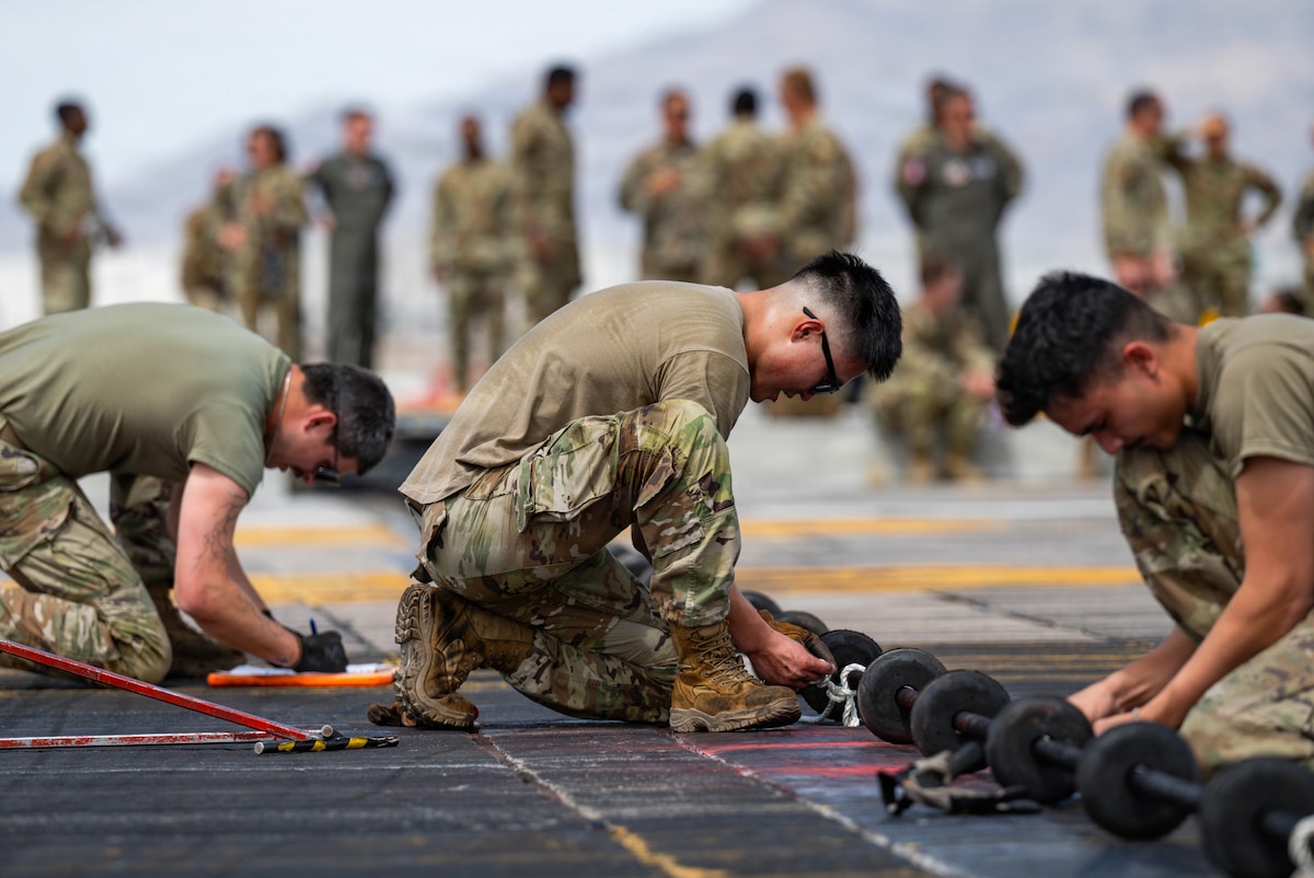 Airman 1st Class Euisol Jung, an electrical power production team member assigned to the 99th Civil Engineer Squadron, assembles a BAK-12 aircraft arresting cable at Nellis Air Force Base, Nev., April 6, 2026. Jung participated in a competition designed to test operational capabilities in the event a fighter aircraft must abort a takeoff or conduct an emergency landing. (U.S. Air Force photo by Airman Annika Schermerhorn)