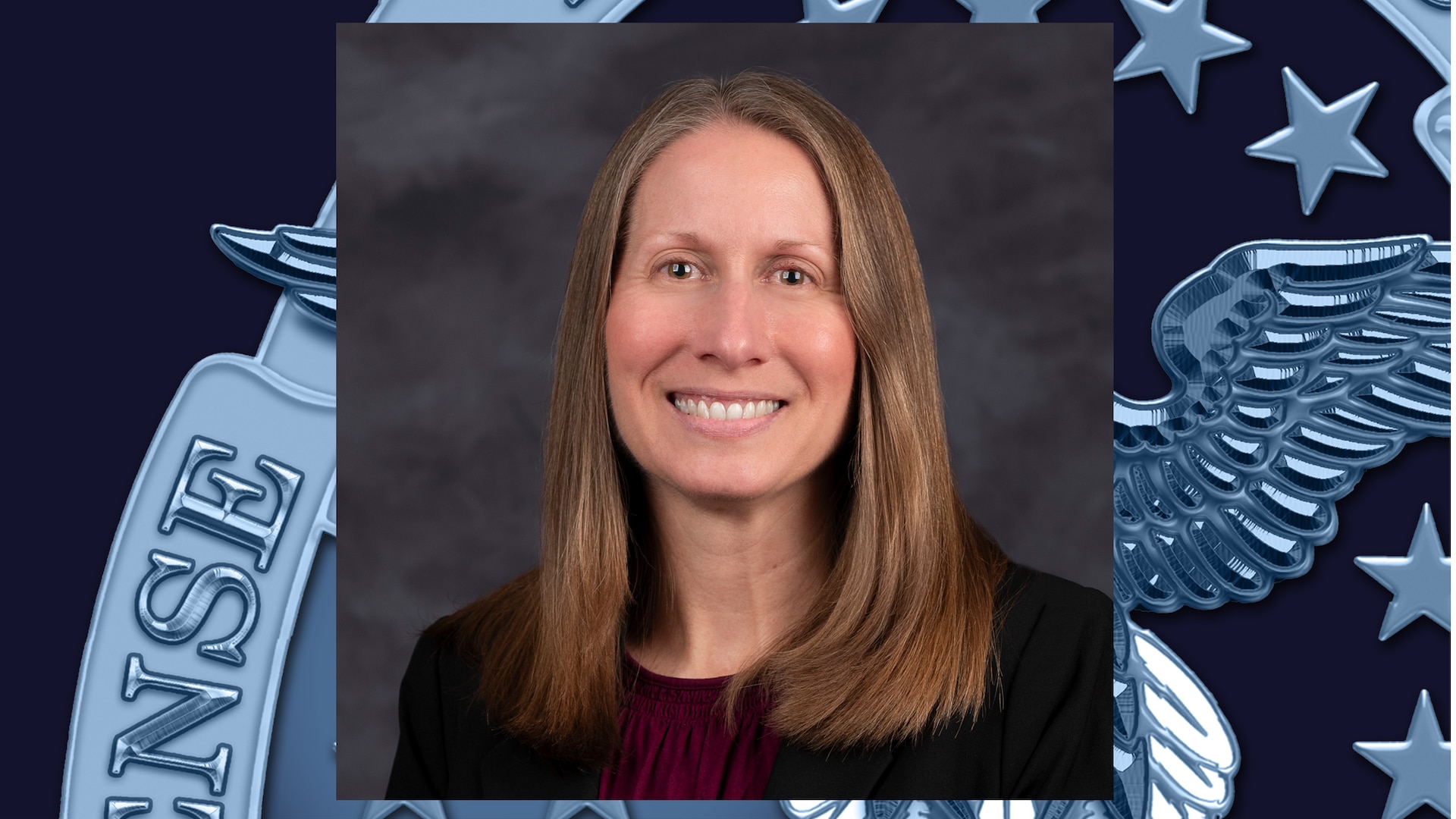 headshot of woman with straight, shoulder-length, light brown/blonde hair, wearing dark burgundy shirt and black blazer
