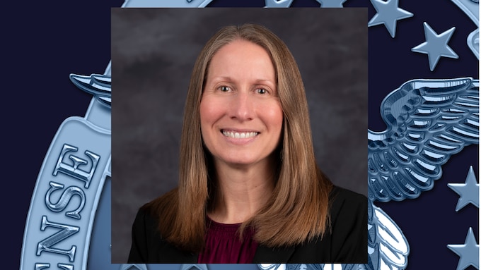 headshot of woman with straight, shoulder-length, light brown/blonde hair, wearing dark burgundy shirt and black blazer