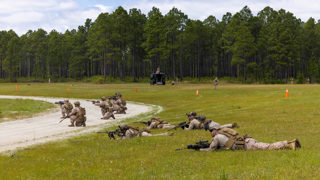 U.S. Marines with Alpha Company, 1st Battalion, 8th Marine Regiment, 2nd Marine Division, rehearse fire and maneuver techniques during an amphibious combat vehicle integration training at a landing zone aboard Marine Corps Base Camp Lejeune, North Carolina, April 27, 2026. The ACV integration training provides Marines with the knowledge and skills required to safely execute amphibious operations. (U.S. Marine Corps photo by Lance Cpl. Carla Perez Ramirez)