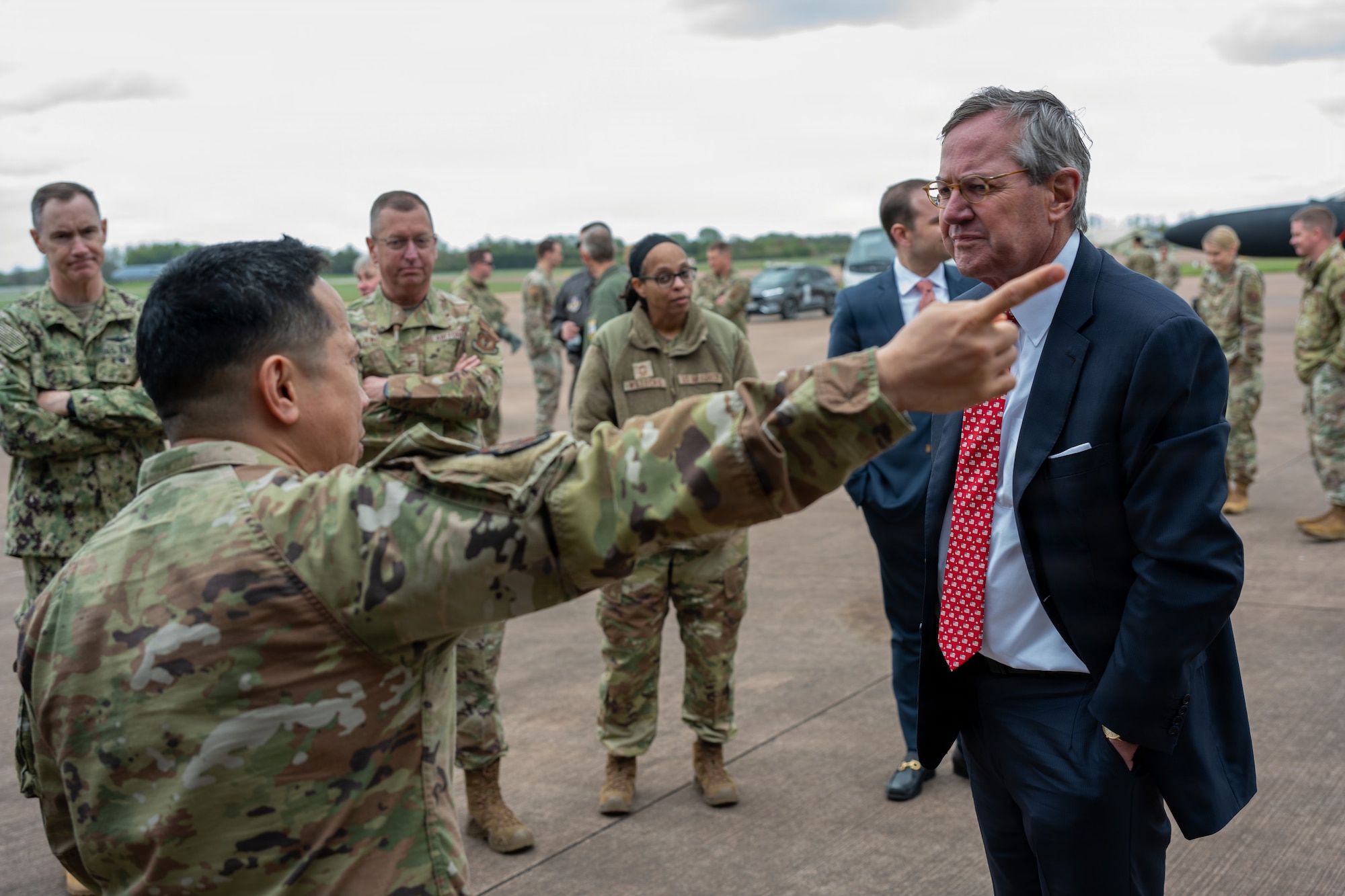 Warren E. Stephens, U.S. Ambassador to the United Kingdom, speaks with U.S. Air Force Maj. Marques L. Reyes, 420th Munitions Squadron commander