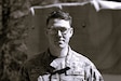 U.S. Army Sgt. David Thomson, a public affairs specialist with the 109th Mobile Public Affairs Detachment, currently deployed to Germany in support of U.S. Special Operations Command Europe, poses for a photo at Fort Indiantown Gap, Pennsylvania, April 7, 2024. (U.S. Army National Guard photo illustration by Capt. Leanne Trindel)