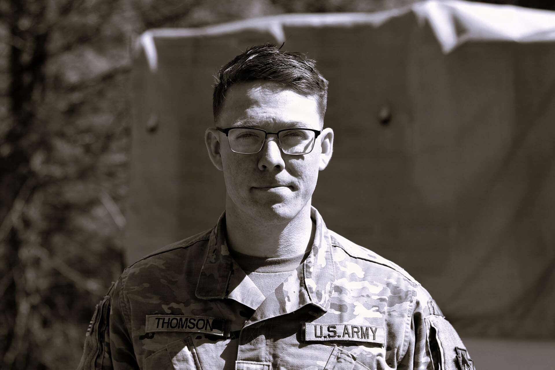U.S. Army Sgt. David Thomson, a public affairs specialist with the 109th Mobile Public Affairs Detachment, currently deployed to Germany in support of U.S. Special Operations Command Europe, poses for a photo at Fort Indiantown Gap, Pennsylvania, April 7, 2024. (U.S. Army National Guard photo illustration by Capt. Leanne Trindel)