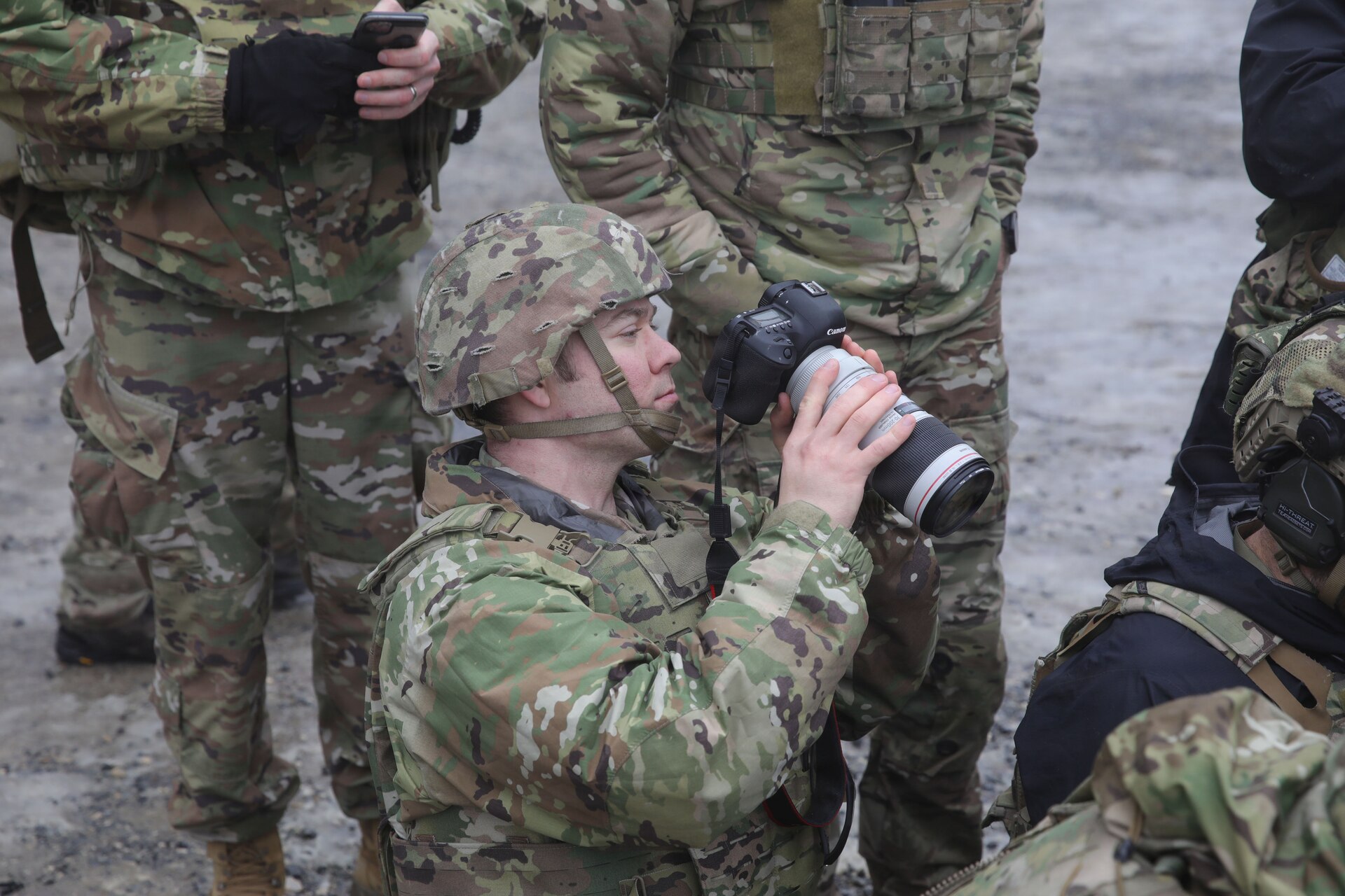U.S. Army Sgt. David Thomson, a public affairs specialist with the 109th Mobile Public Affairs Detachment, currently deployed to Germany in support of U.S. Special Operations Command Europe, takes a video of Green Berets during Exercise Deep Strike at Hohenfels, Germany, February 22, 2026. (U.S. Army National Guard photo by Sgt. Glenn Brennan)