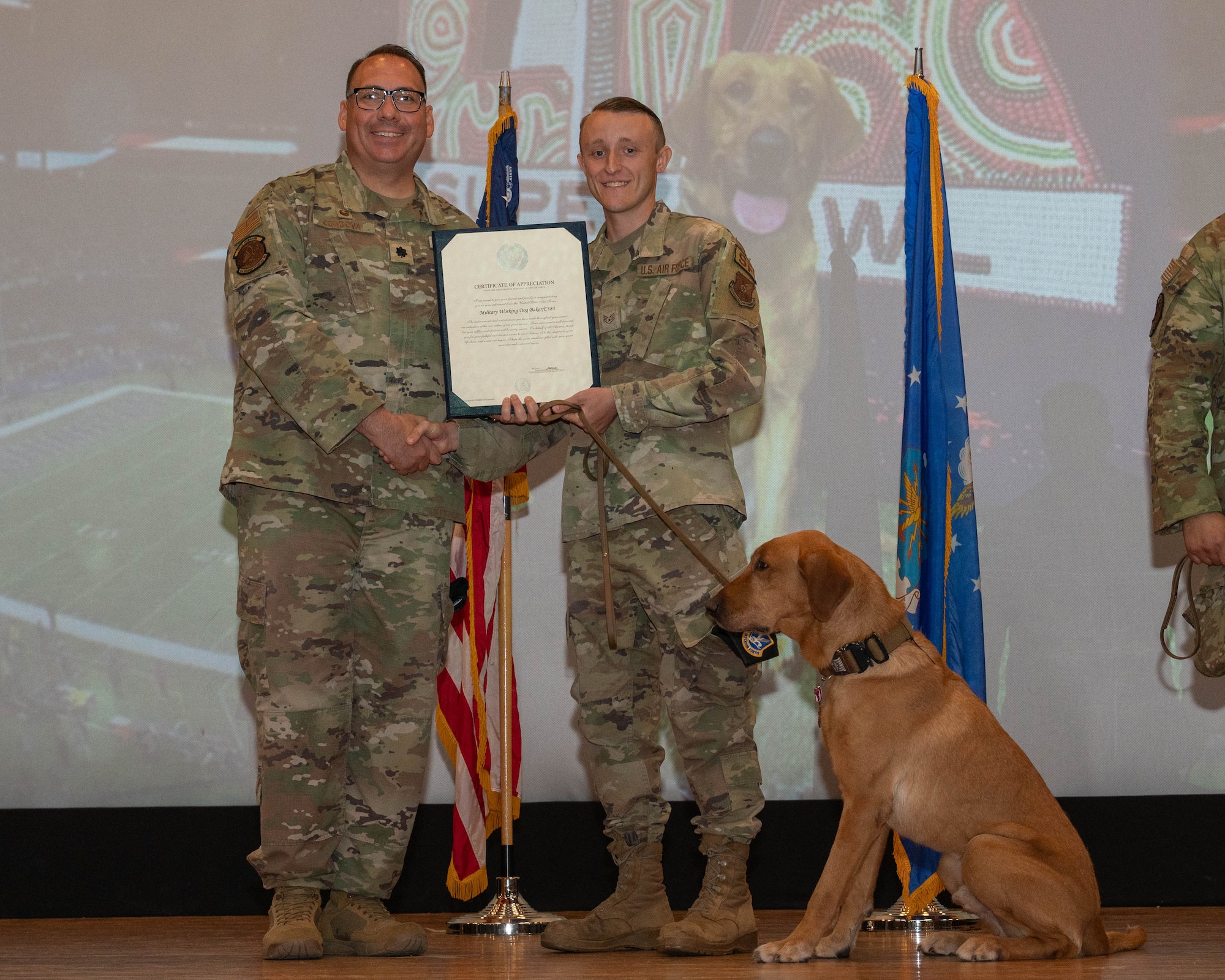 U.S. Air Force Lt. Col. Richard Cordova, 7th Security Forces Squadron commander, presents a certificate of appreciation to Staff Sgt. Bryce Conway, 7th SFS military working dog handler, for MWD Baker during a retirement ceremony at Dyess Air Force Base, Texas, April 29, 2026. The certificate recognized Baker’s four years and nine months of dedicated service in patrol and detection operations, contributing to the overall security and safety of Dyess AFB. (U.S. Air Force photo by Airman 1st Class William Neal)