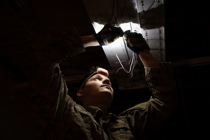 Airman fixing light