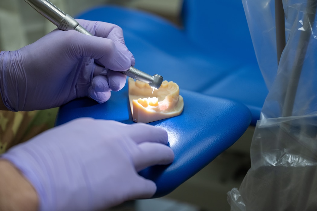 A dental handpiece is positioned over a dental training model at Altus Air Force Base, Oklahoma, April 13, 2026. The demonstration was part of a “Boots on the Ground” immersion tour for the Altus Air Force Base command team. (U.S. Air Force photo by Airman 1st Class Nathan Langston)